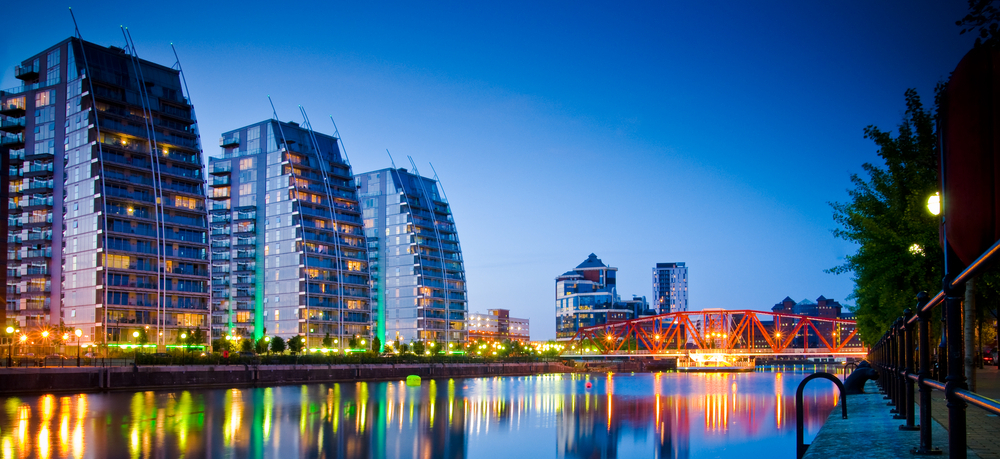 High-rise buildings and bridge over river in Manchester